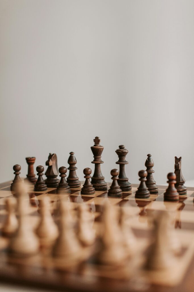 Close-up of a classic wooden chess set on a chessboard emphasizing the strategic game pieces.